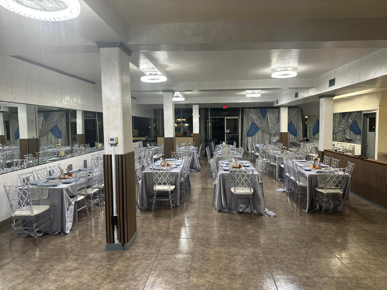 Bud's Buffet dining room set with silver linens and chiavari chairs for a private event