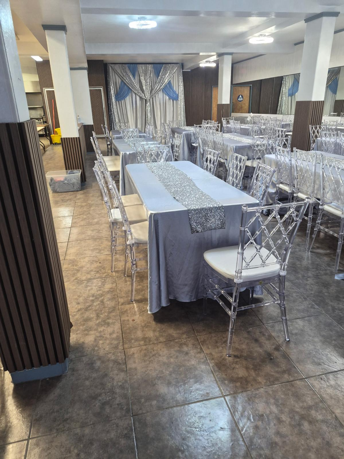Long banquet tables with silver runners ready for guests at Bud's Buffet